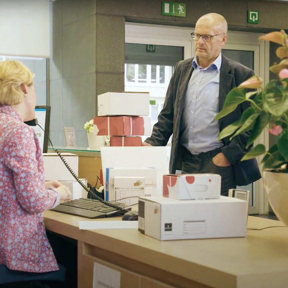 Bringme Office In Setting Overloaded receptionist With parcels And visitors